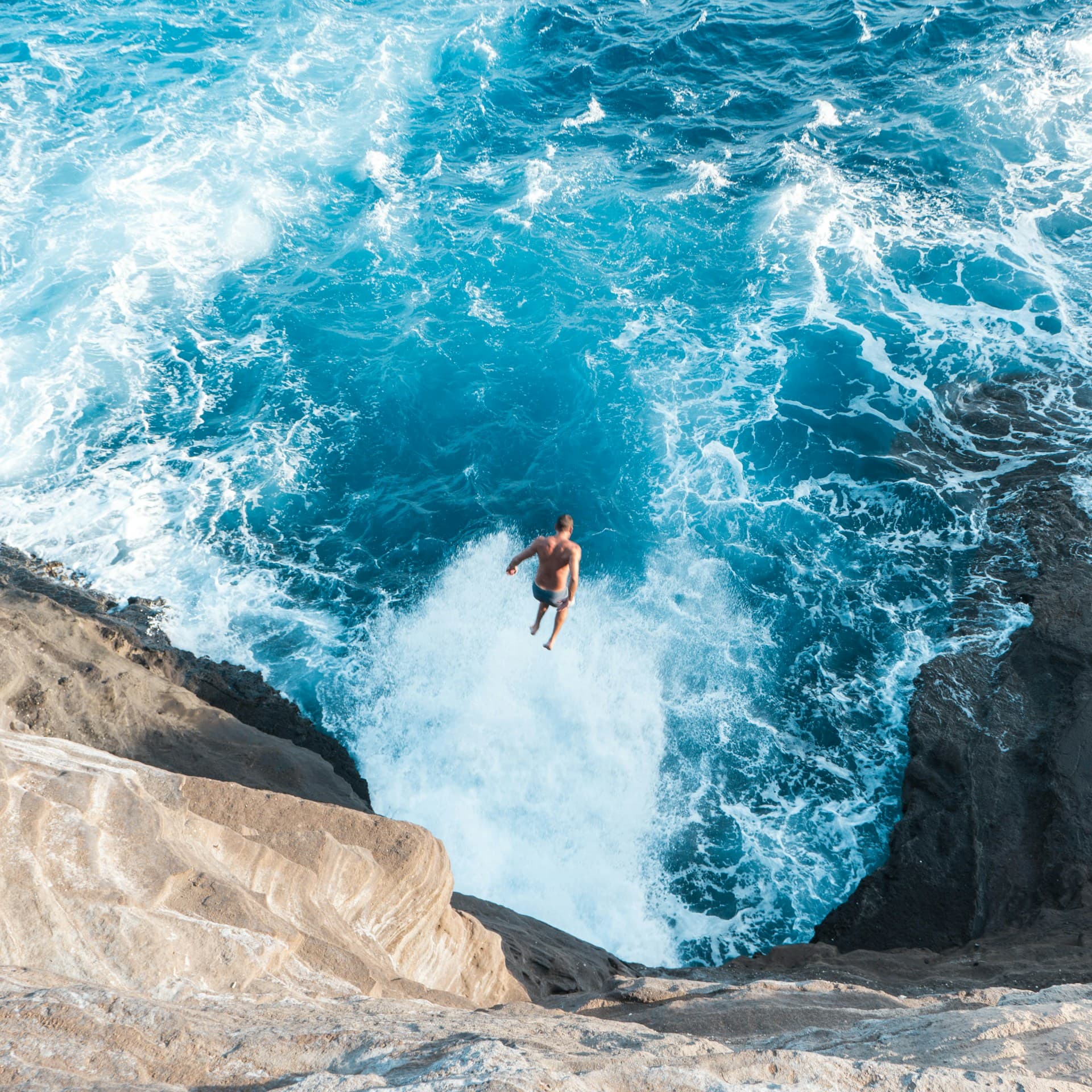 Man jumping off of Hawaii’s spitting cave
