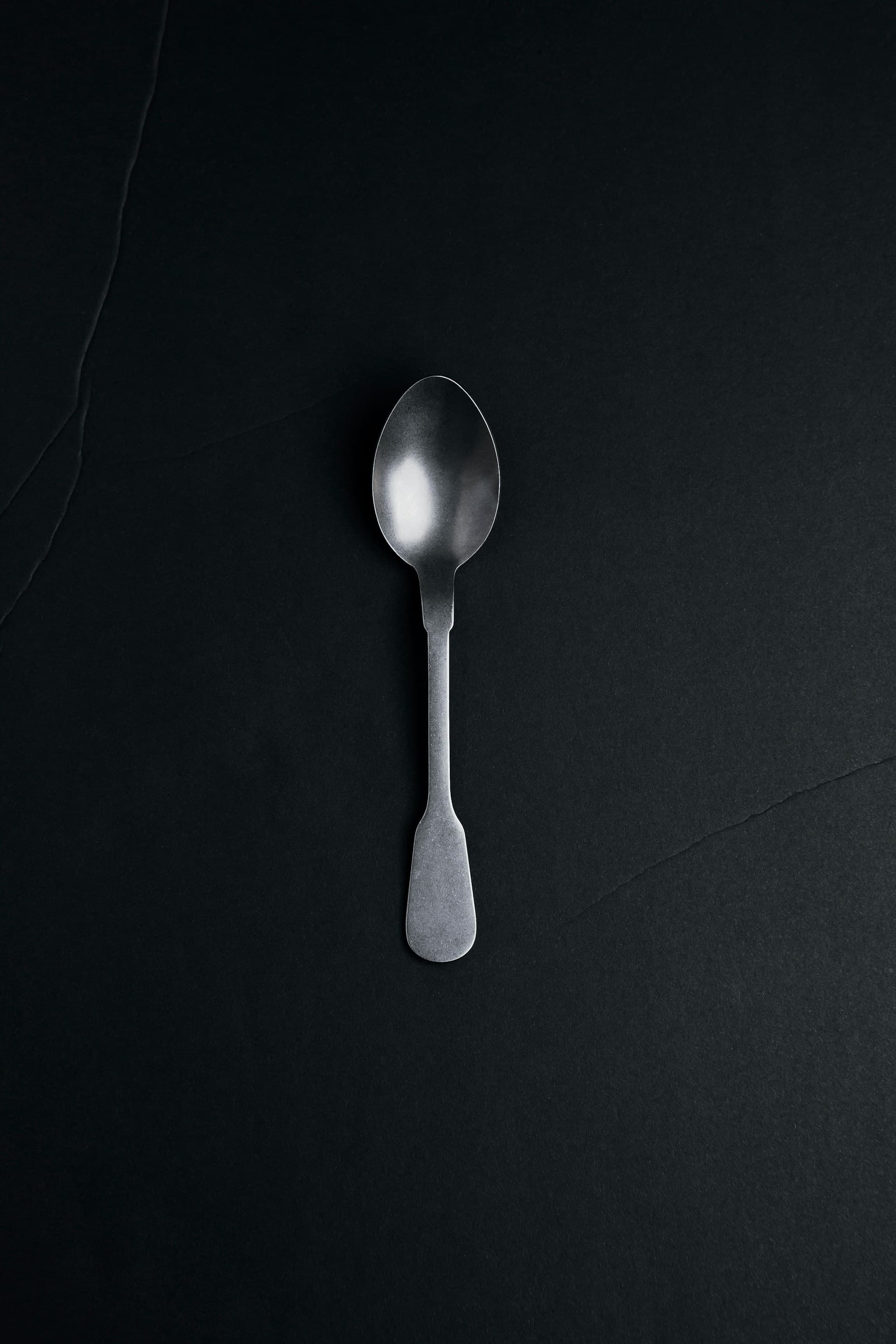 Image on a spoon on a dark table